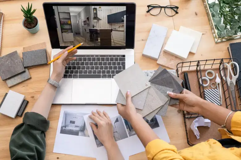 Designers examining 3D renderings of an interior design project Designers examining 3D renderings of an interior design project
