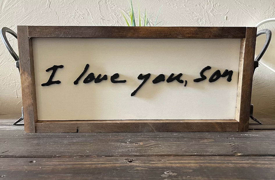 Handwritten type used in a wooden sign frame Handwritten type used in a wooden sign frame
