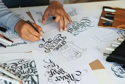 Graphic designer creating typefaces using pen and paper