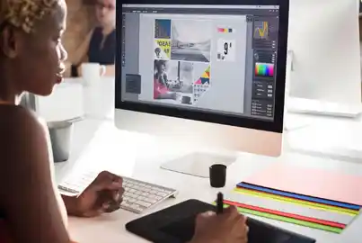 A designer creating a poster on their desktop