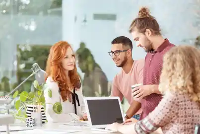 Team of graphic designers collaborating in a bright office space Team of graphic designers collaborating in a bright office space