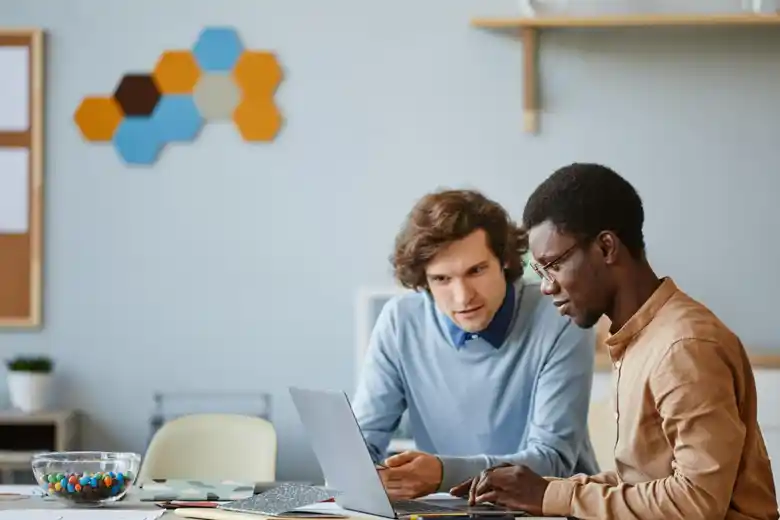 Experience designers using their laptops for secondary research Experience designers using their laptops for secondary research