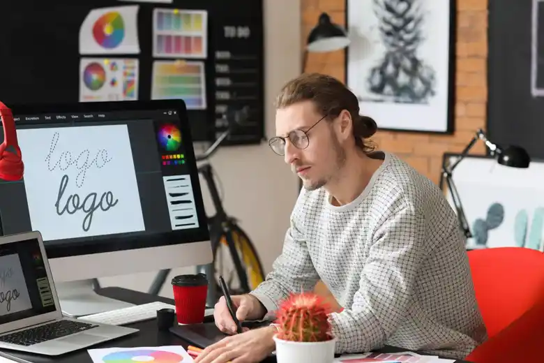 A Graphic Designer finalising the color scheme for the logo A Graphic Designer finalising the color scheme for the logo