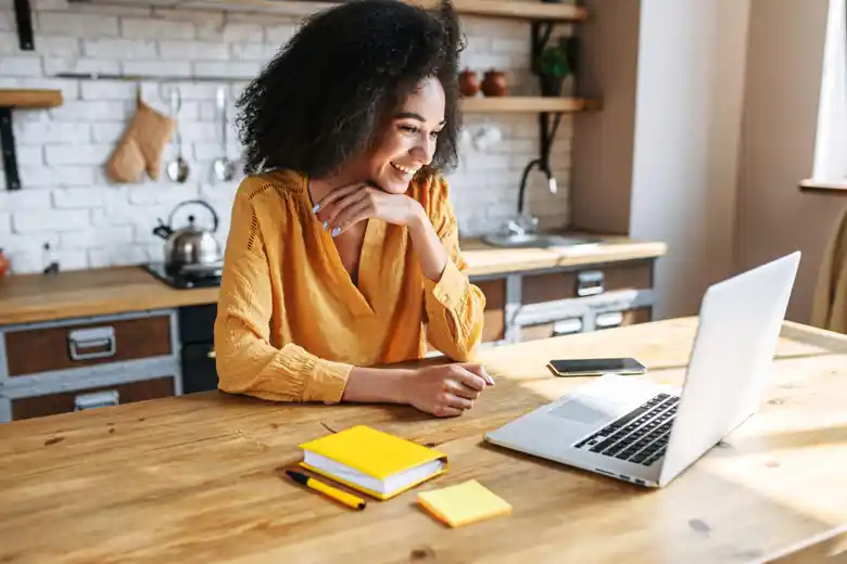 Logo designer reading on their laptop