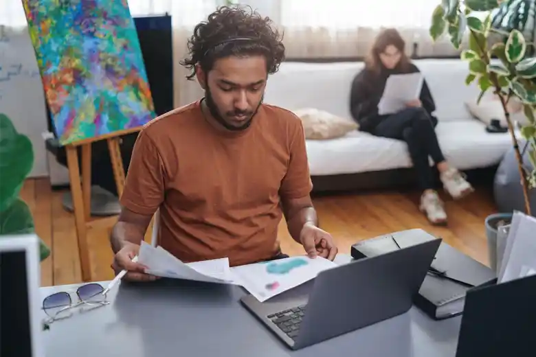 Graphic designer reviewing print designs Graphic designer reviewing print designs