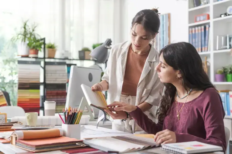 Interior decorators discussing colour palettes Interior decorators discussing colour palettes