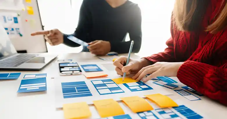 Two UX designers doing card sorting for user research