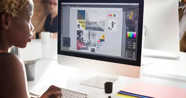 A designer creating a poster on their desktop