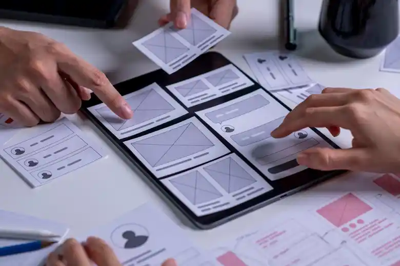 UI designers examining the features and flow of an application