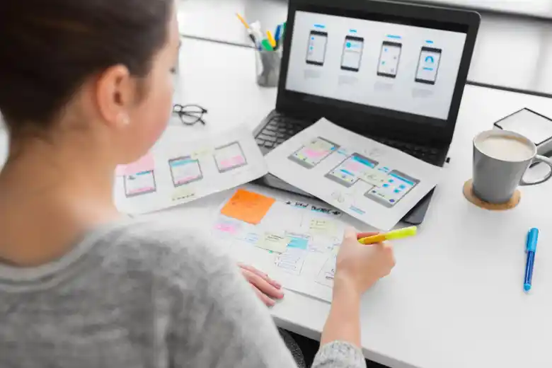 Web designer creating navigation wireframes for mobile applications Web designer creating navigation wireframes for mobile applications