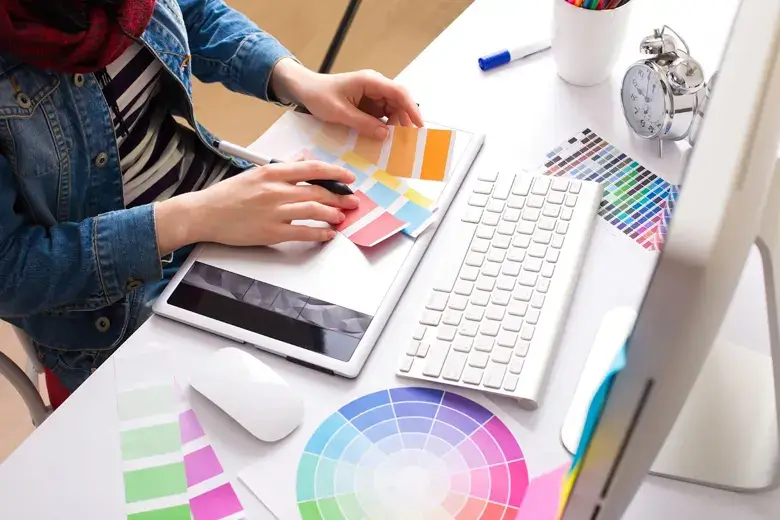 Graphic illustrator examining the colour scheme for a project