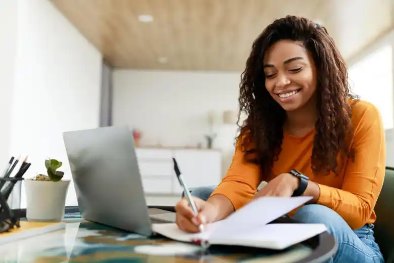 Woman writing on notepad Woman writing on notepad