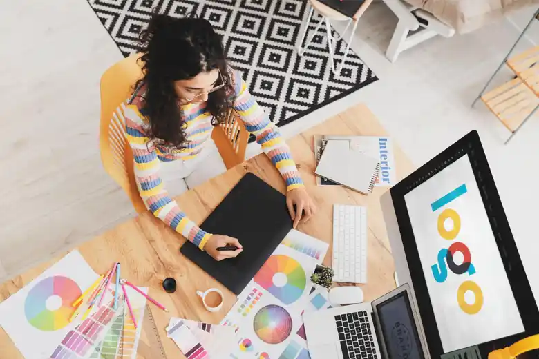 Designer creating a brand logo Designer creating a brand logo