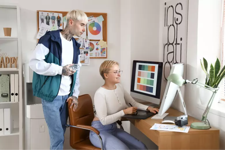 Graphic designers working on a logo together Graphic designers working on a logo together