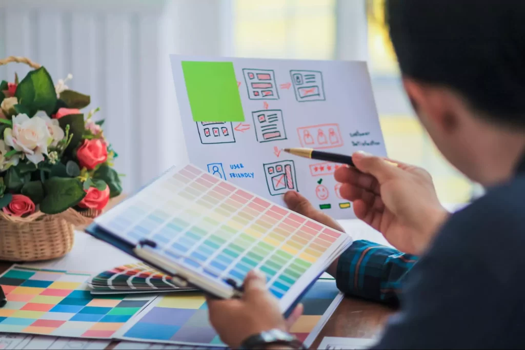 Two UX UI designers working together to decide the colour scheme of the interface Two UX UI designers working together to decide the colour scheme of the interface