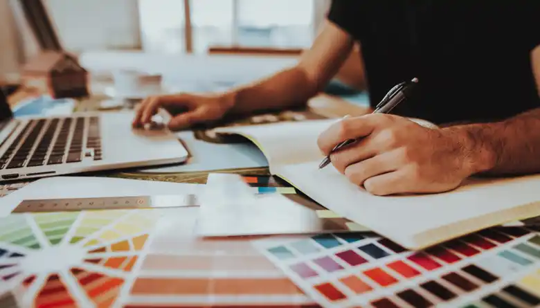 Logo designer using colour theory to create brand identity
