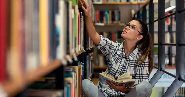 UX Designer reading design thinking books in a library
