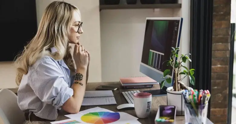 Graphic designer using a colour wheel for a project.