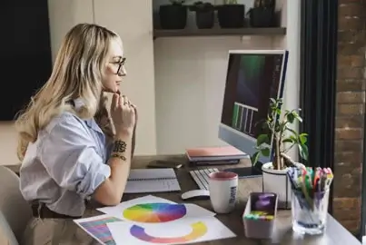 Graphic designer using a colour wheel for a project.