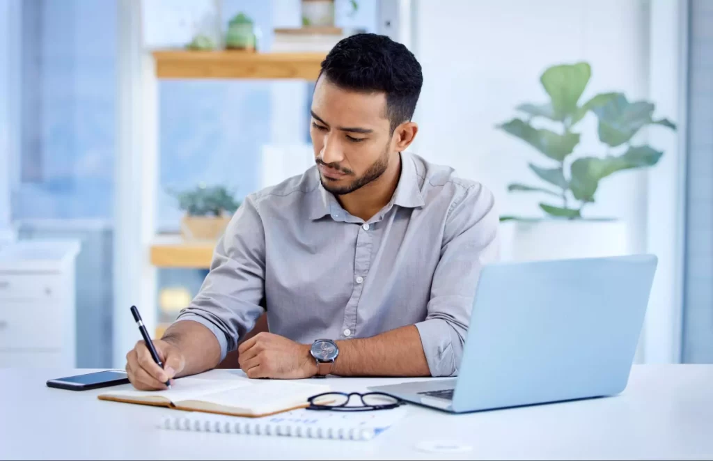 Professional graphic designer making notes in their journal