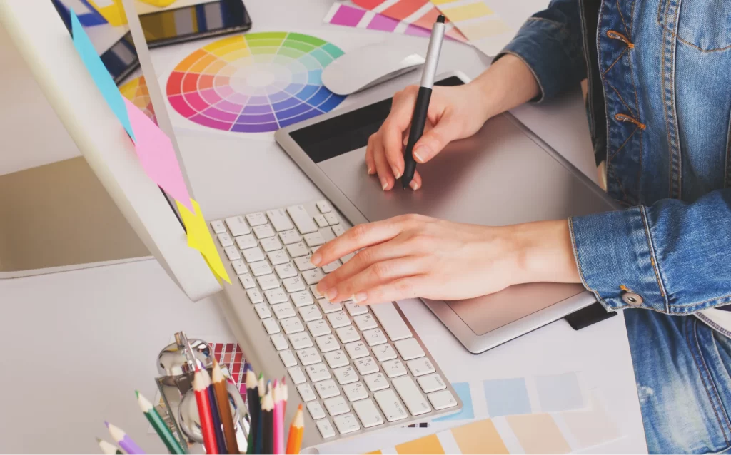 Visual designer using the colour wheel to create illustrations for a project Visual designer using the colour wheel to create illustrations for a project