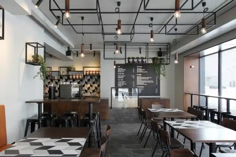 A cafe with industrial lighting fixtures A cafe with industrial lighting fixtures