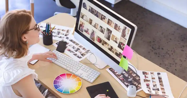 Graphic designer selecting images for a poster design project.