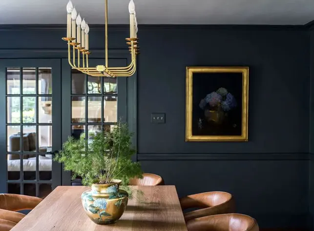 Living room decor incorporating golden accents in light fixtures, tableware and picture frames Living room decor incorporating golden accents in light fixtures, tableware and picture frames