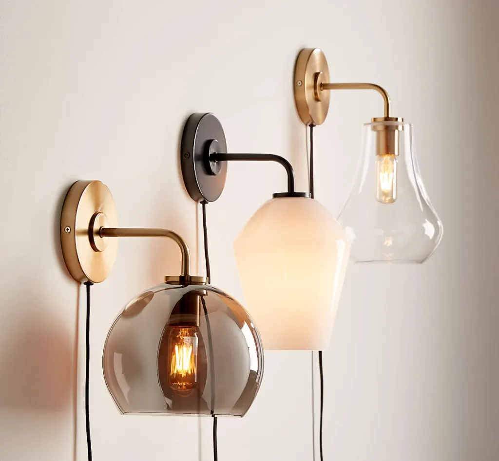 A wall with three scones to provide soft and ambient lighting in the room A wall with three scones to provide soft and ambient lighting in the room