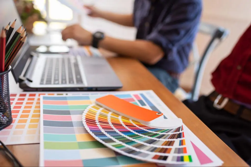 Color palettes and shades next to a laptop Color palettes and shades next to a laptop