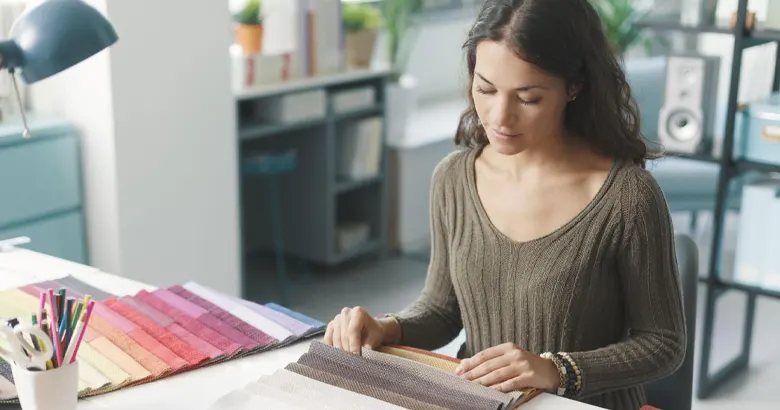 Interior designer examining fabric samples for colour and texture accuracy