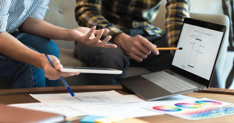 Designers using UI design tools to create a mobile application interface