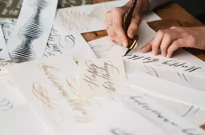 Typography designer ideating on different font styles using a pen