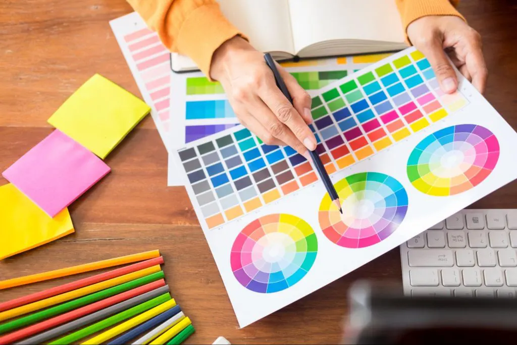 Visual designer learning about colour theory using different colour wheels. Visual designer learning about colour theory using different colour wheels.