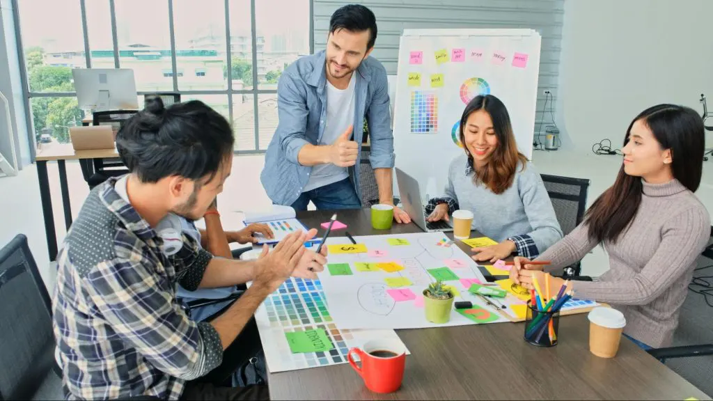 A team of designers brainstorming on a visual marketing collateral. A team of designers brainstorming on a visual marketing collateral.