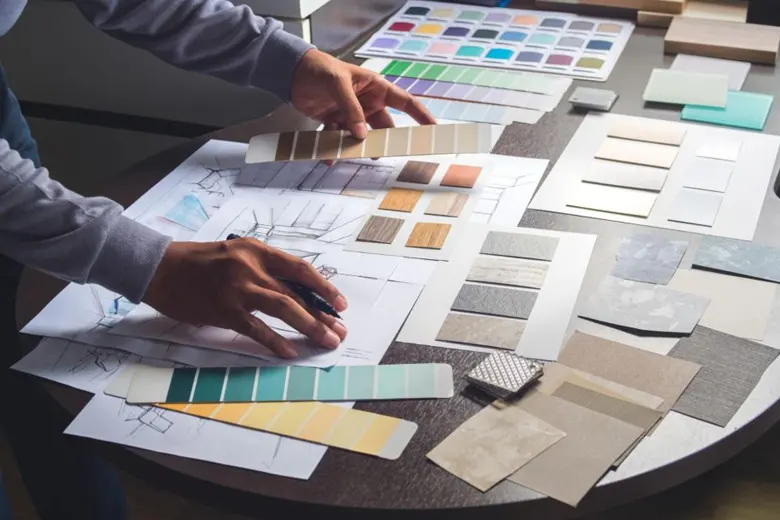 Interior decorator mapping flooring options and materials for project Interior decorator mapping flooring options and materials for project