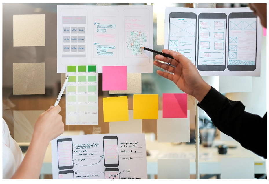 Designers working on the branding of an application interface using colour theory Designers working on the branding of an application interface using colour theory