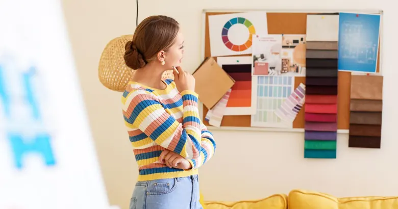 Designer reviewing colour palettes and fabric samples on a mood board.
