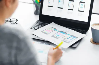 A designer using a UX design software to create a mobile application prototype