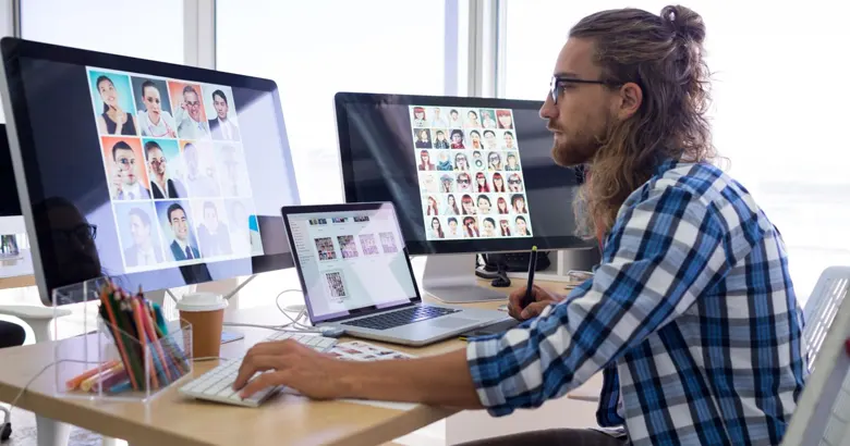Graphic designer working on multiple screens