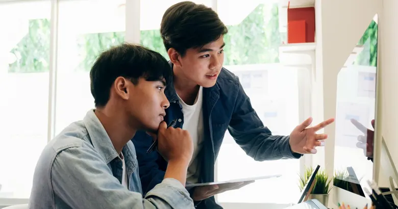 Two designers collaborating on wireframe designs
