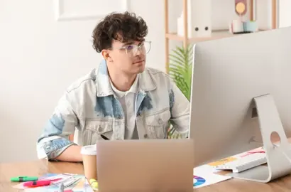 Logo designer creating rough sketches on a laptop