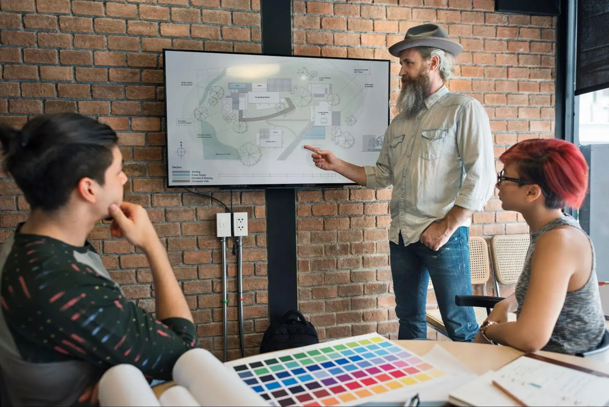 Interior designers discussing the floorplan for a project