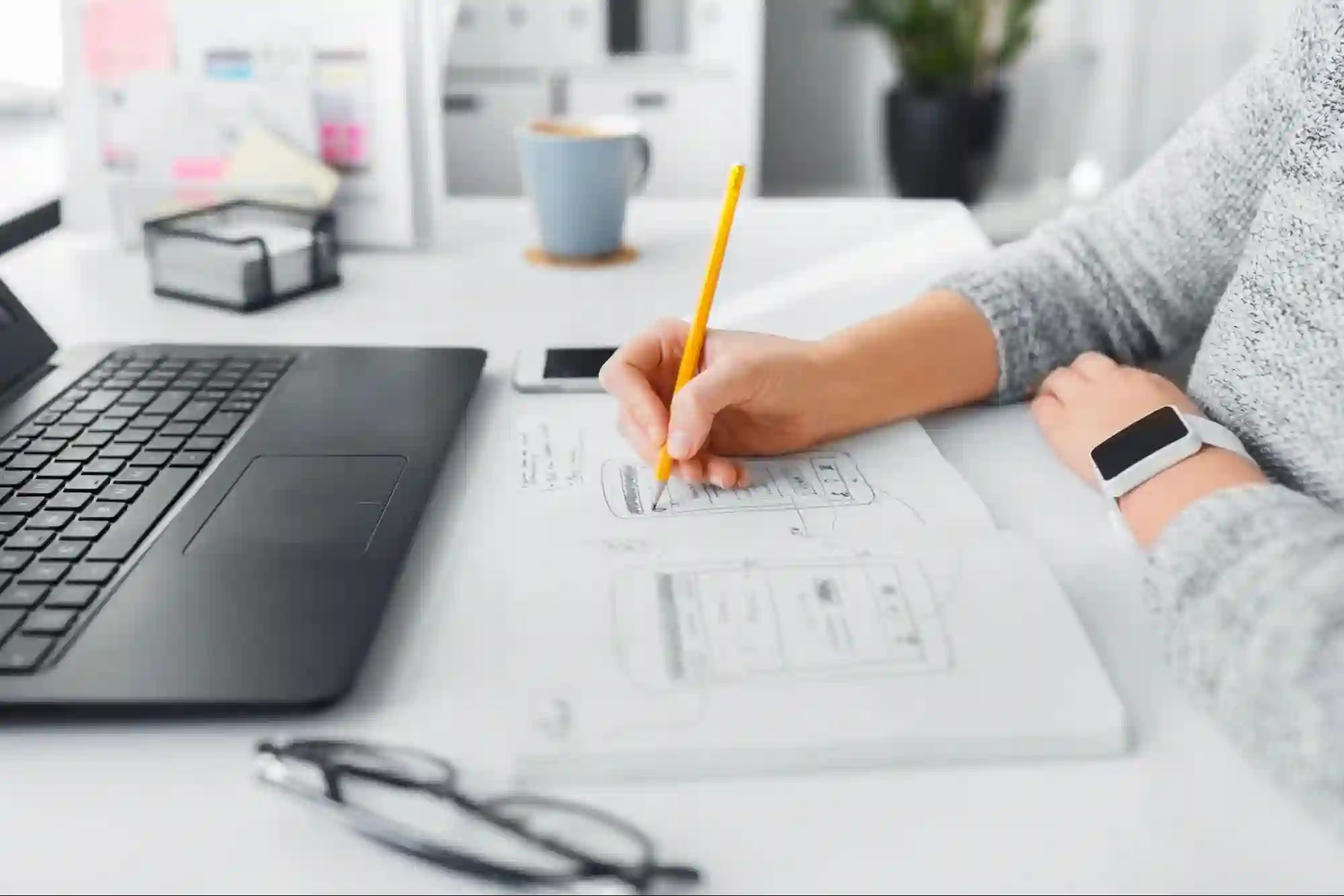 UI UX designer working on a low-fidelity wireframe for an application UI UX designer working on a low-fidelity wireframe for an application