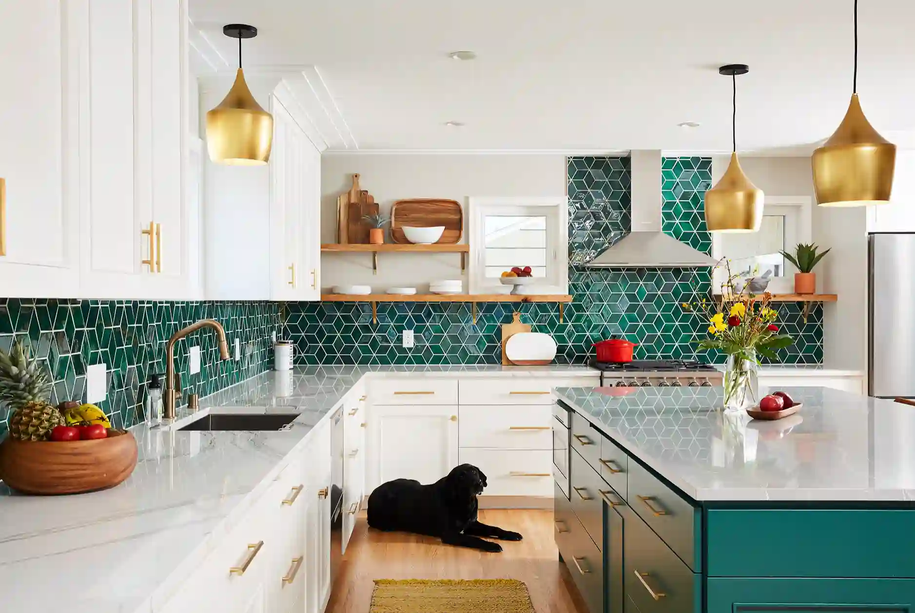 An open kitchen with ceiling lights, a white marble top and an island kitchen top
An open kitchen with ceiling lights, a white marble top and an island kitchen top