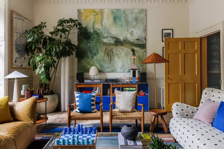 Living room with an oversized abstract artwork on the wall. Living room with an oversized abstract artwork on the wall.
