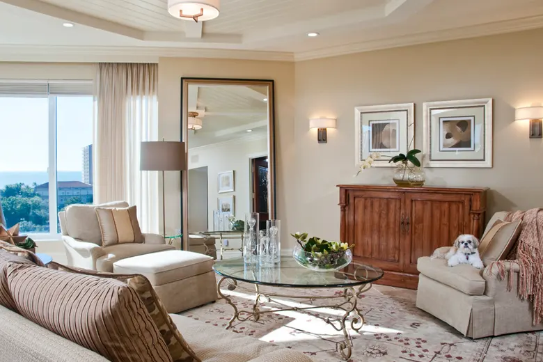 Living room with a large mirror reflecting natural light. Living room with a large mirror reflecting natural light.