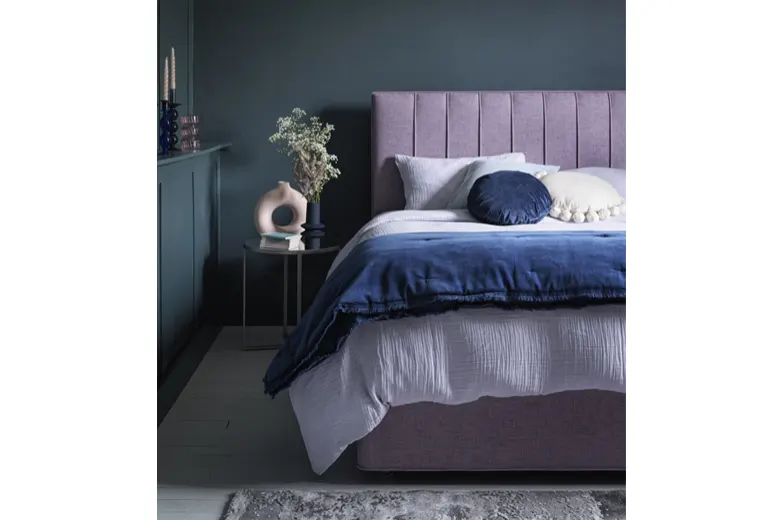 Small bedroom with dark navy walls paired with lighter furnishings. Small bedroom with dark navy walls paired with lighter furnishings.