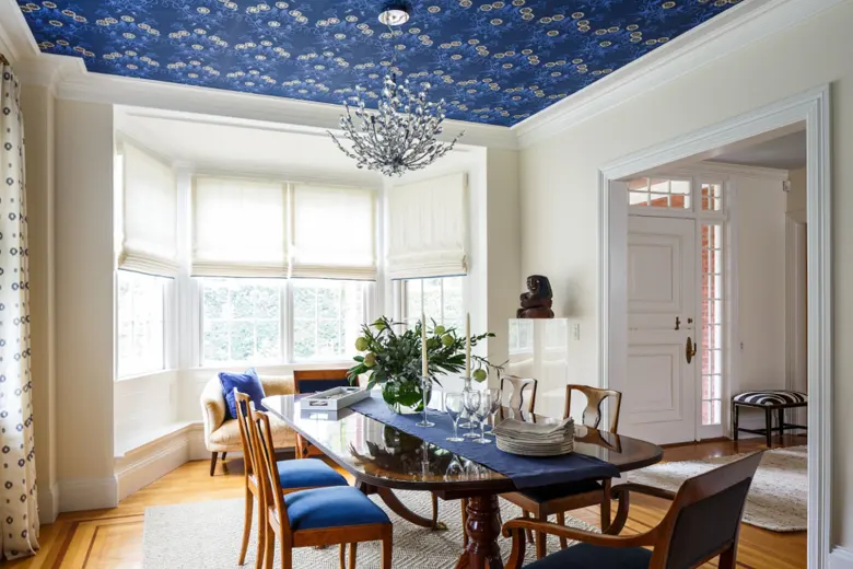 Ceiling with vibrant blue wallpaper and neutral-coloured walls. Ceiling with vibrant blue wallpaper and neutral-coloured walls.