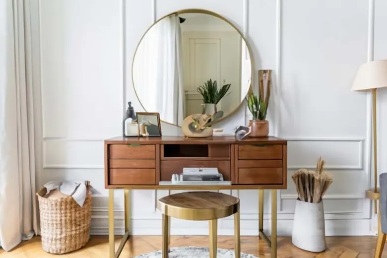 Bedroom with a vanity table, stool, and large mirror in a dressing corner.
Bedroom with a vanity table, stool, and large mirror in a dressing corner.